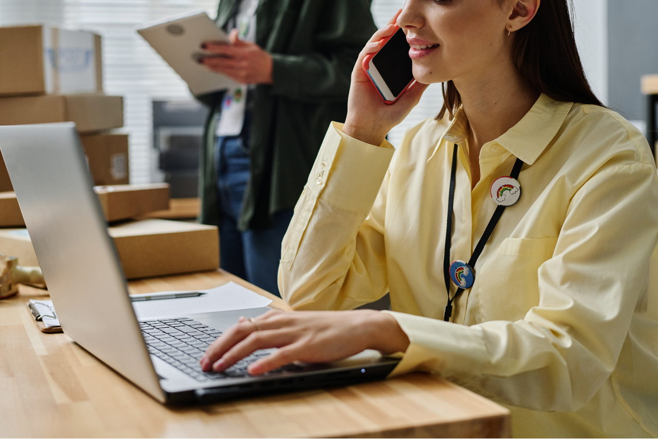 Young woman assisting customers online and by phone, representing ecommerce outsourcing services.